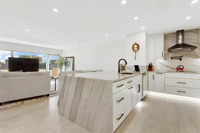 a large white kitchen with cabinets
