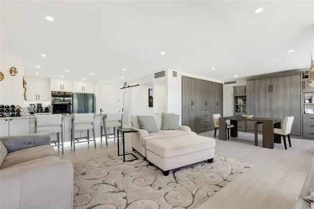 a living room with lots of furniture and view of kitchen