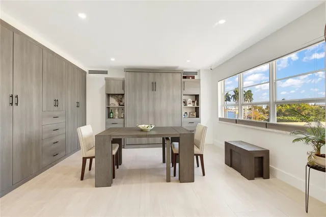 a view of a kitchen with dining room and windows