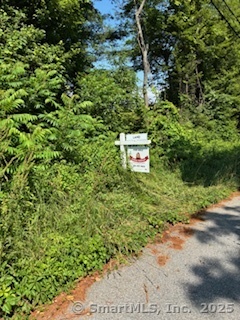 115 McBride Road Litchfield, CT 06759 - Photo 18 of 28 a backyard of a house with a yard and garage