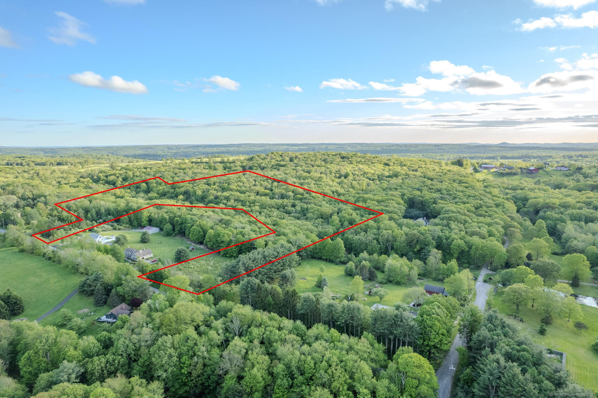 115 McBride Road Litchfield, CT 06759 - Photo 21 of 28 a view of a city with lush green forest