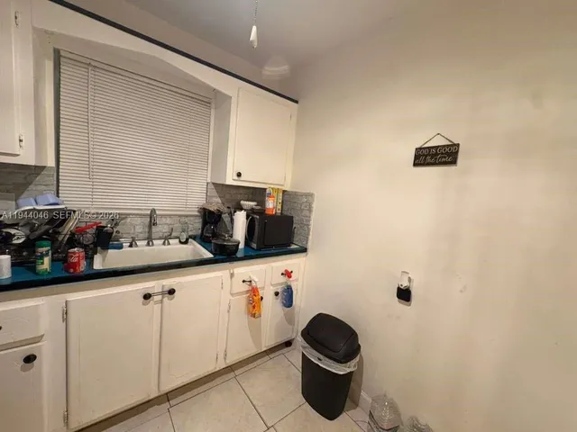 a white refrigerator freezer and a stove sitting inside of a kitchen