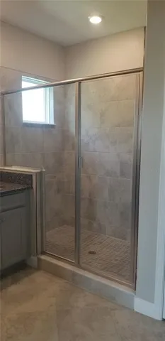 a bathroom with a glass shower door