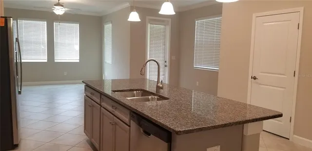 a kitchen with a sink a counter space and a window