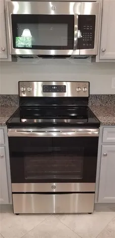 a stove top oven sitting inside of a kitchen