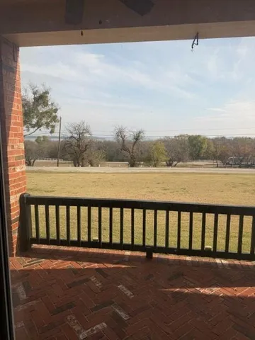 a view of balcony with furniture and city view