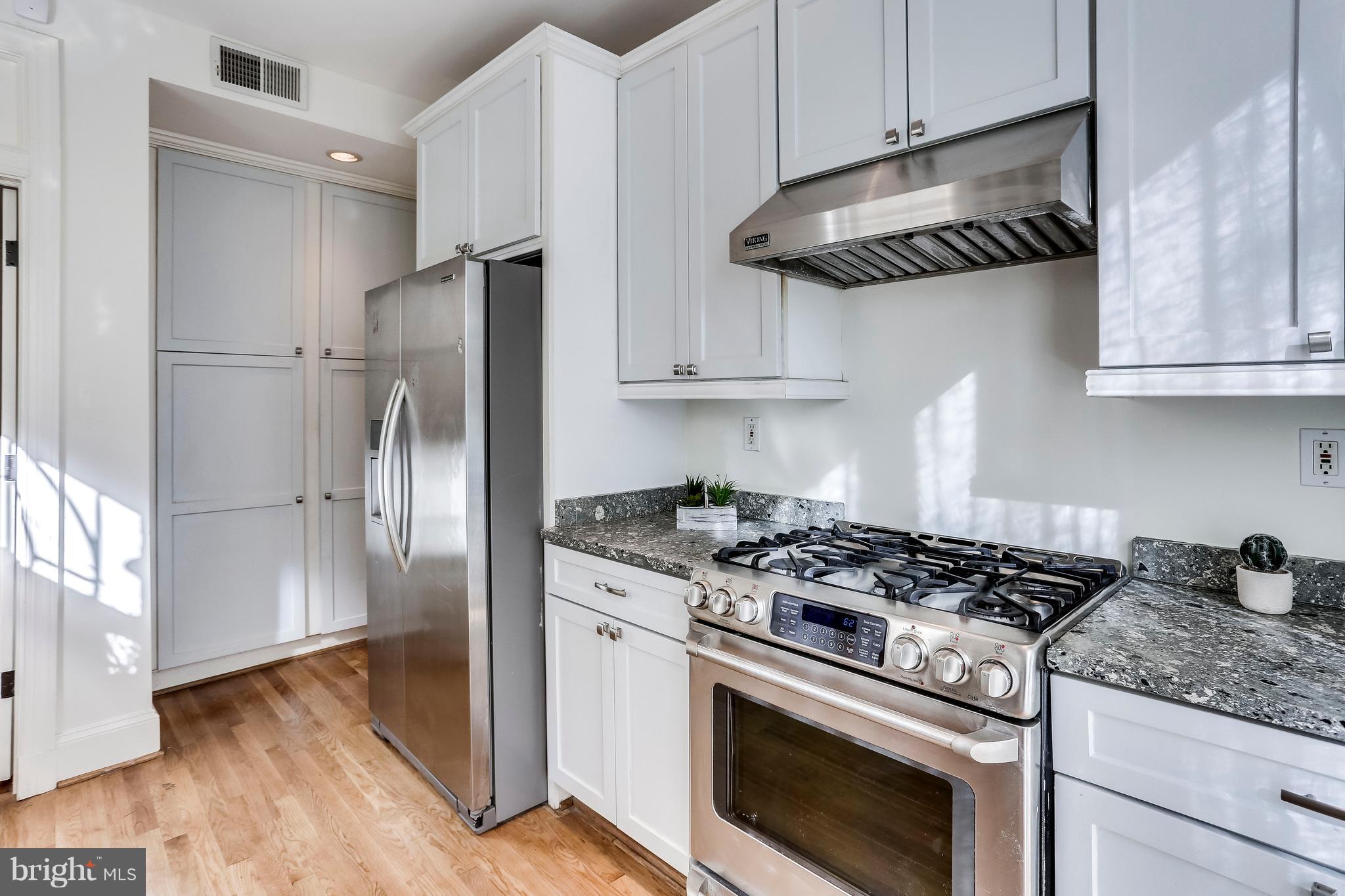 123 Tennessee Avenue Northeast Washington, DC 20002 - Photo 11 of 27 a kitchen with stainless steel appliances granite countertop a stove a refrigerator and a granite counter tops