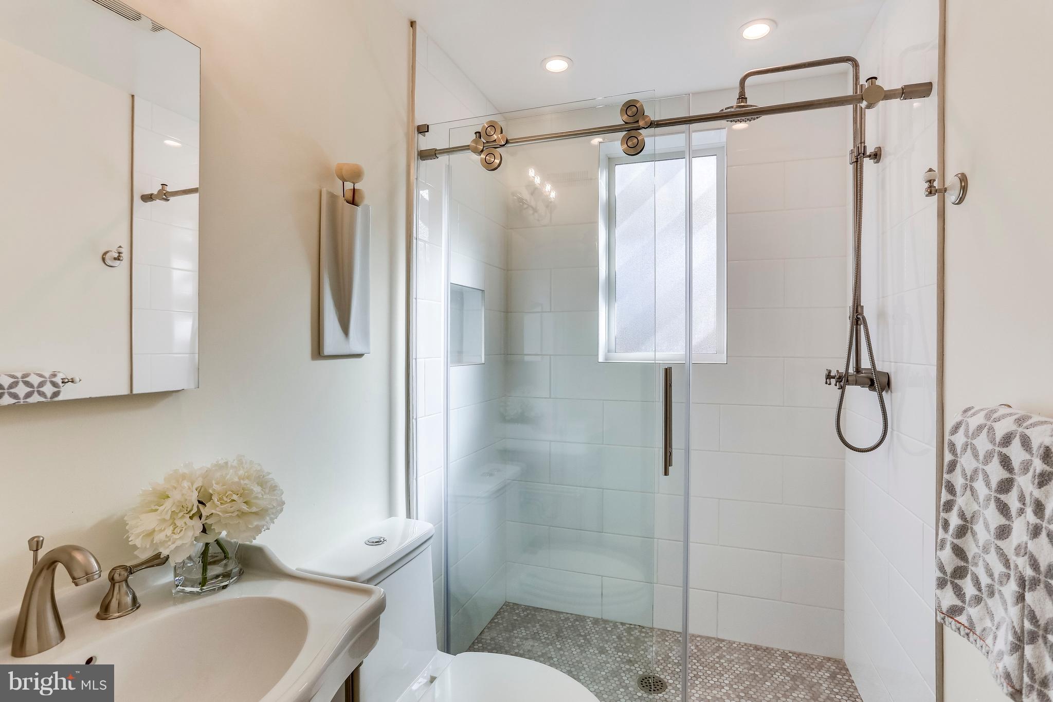 123 Tennessee Avenue Northeast Washington, DC 20002 - Photo 19 of 27 a bathroom with a sink toilet and shower