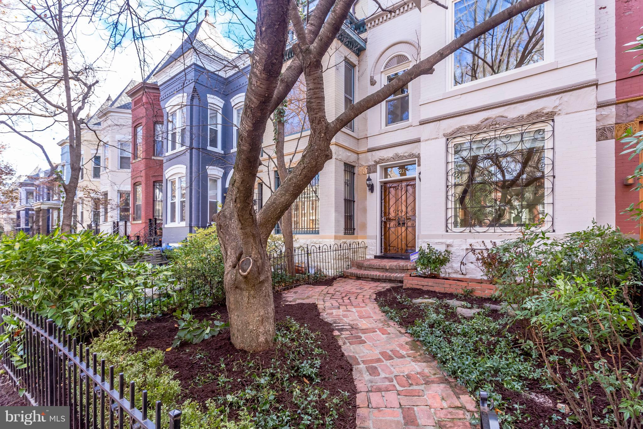 123 Tennessee Avenue Northeast Washington, DC 20002 - Photo 2 of 27 a front view of a multi story residential apartment building with yard and bench