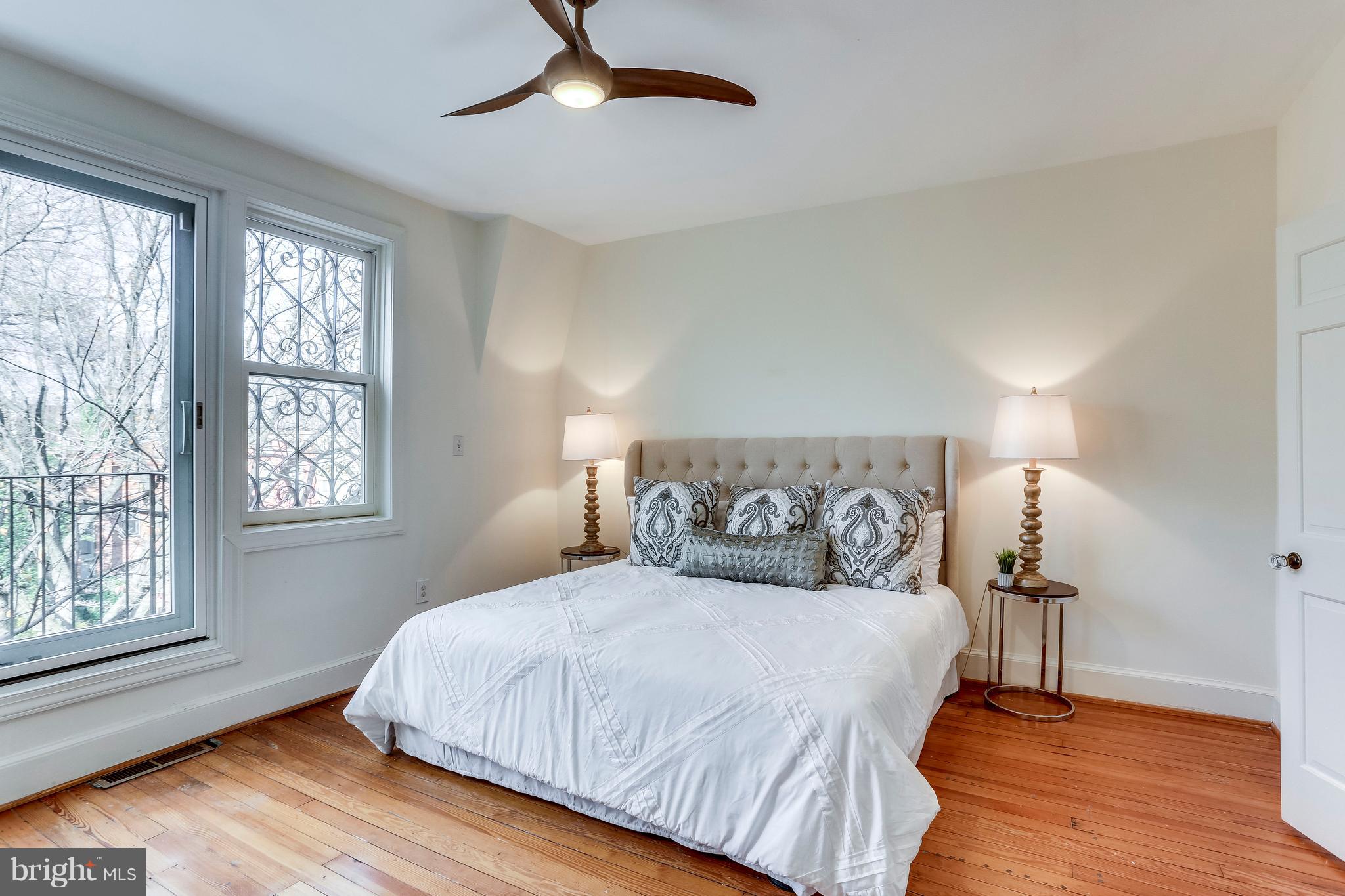 123 Tennessee Avenue Northeast Washington, DC 20002 - Photo 24 of 27 a bedroom with a bed and wooden floor