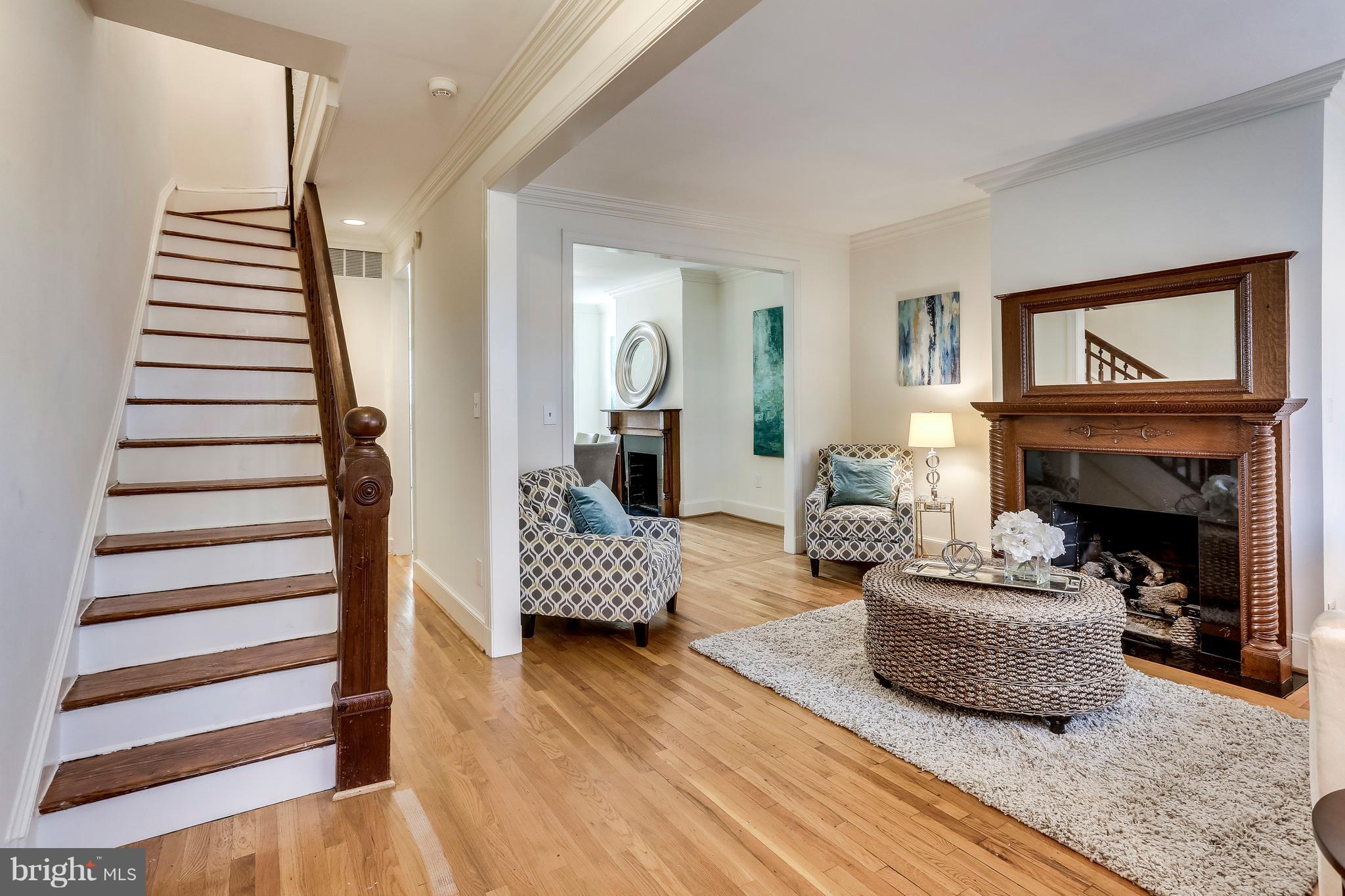 123 Tennessee Avenue Northeast Washington, DC 20002 - Photo 3 of 27 a living room with furniture and a fireplace
