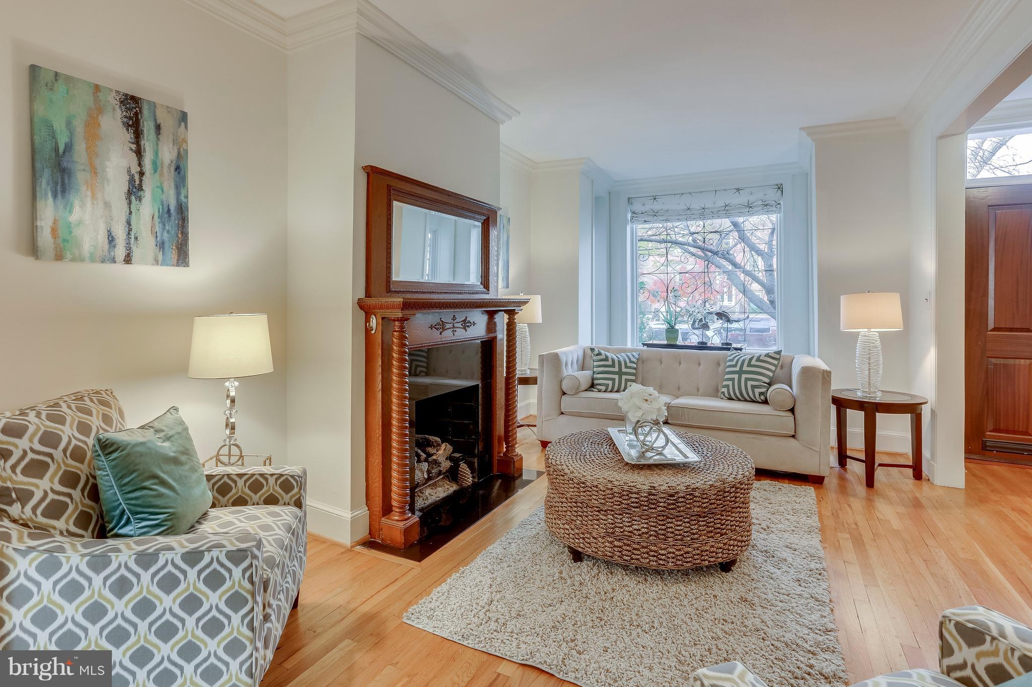 123 Tennessee Avenue Northeast Washington, DC 20002 - Photo 5 of 27 a living room with furniture and a fireplace