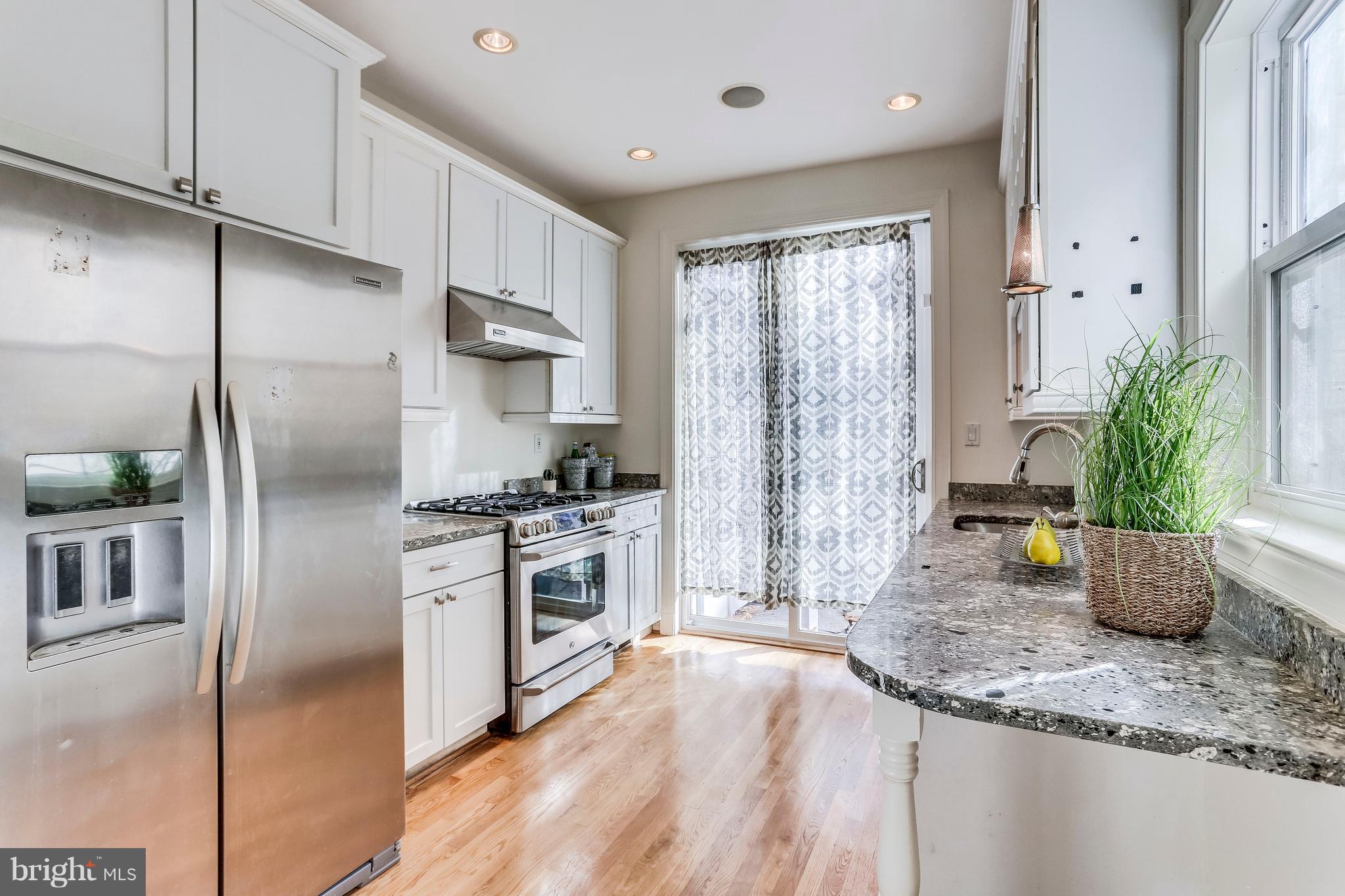 123 Tennessee Avenue Northeast Washington, DC 20002 - Photo 8 of 27 a kitchen with stainless steel appliances granite countertop a refrigerator a stove a sink and white cabinets