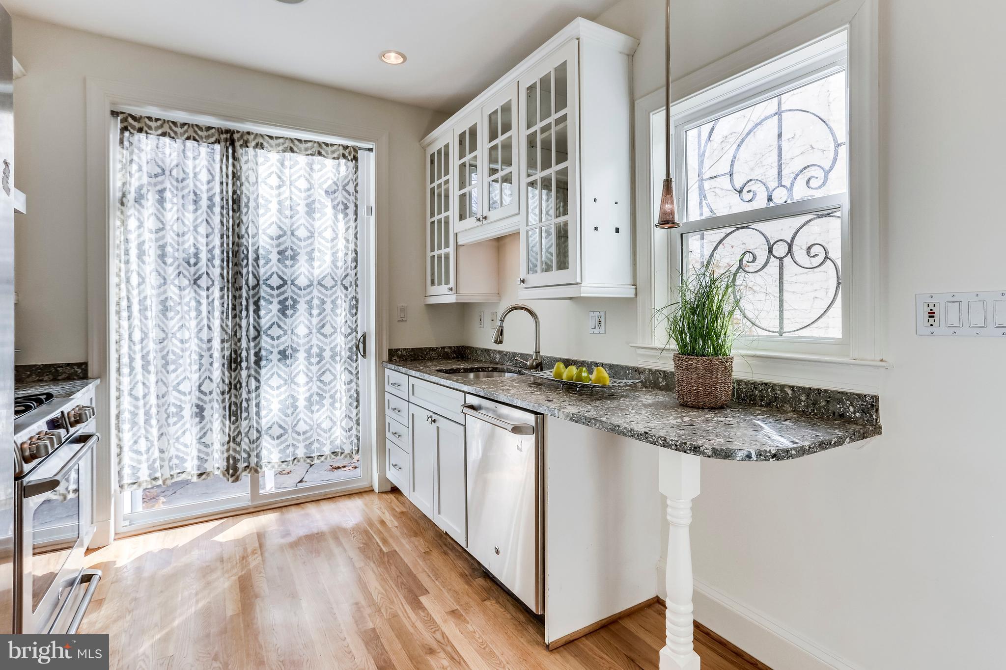 123 Tennessee Avenue Northeast Washington, DC 20002 - Photo 9 of 27 a kitchen with stainless steel appliances granite countertop a sink a stove a counter space and cabinets
