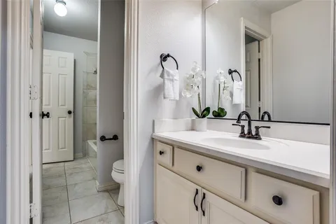 a bathroom with a sink a toilet and a mirror
