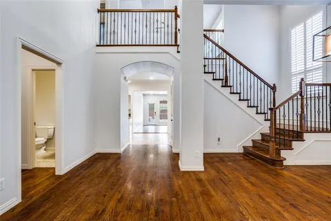 a view of entryway and hall with wooden floor