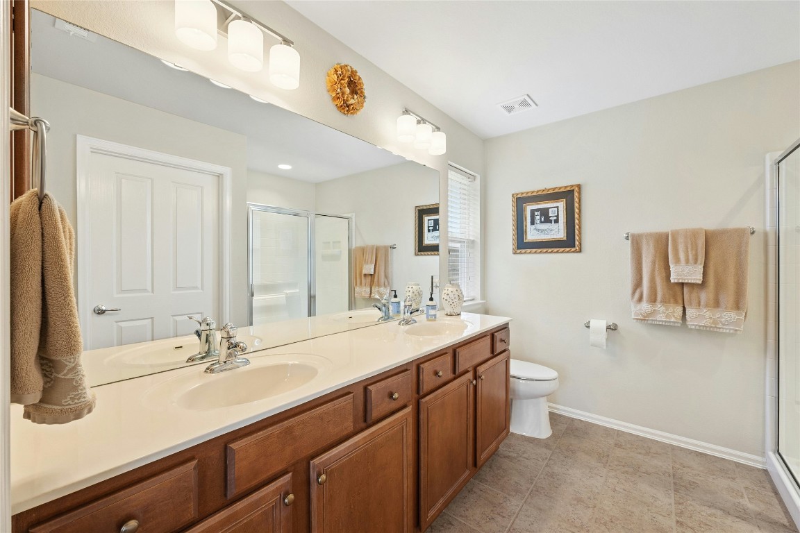 104 Monument Hill Trail Georgetown, TX 78633 - Photo 17 of 30 a bathroom with a sink double vanity granite and a toilet