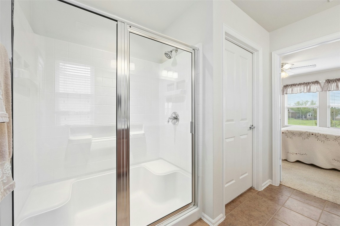 104 Monument Hill Trail Georgetown, TX 78633 - Photo 18 of 30 a bathroom with a glass shower door