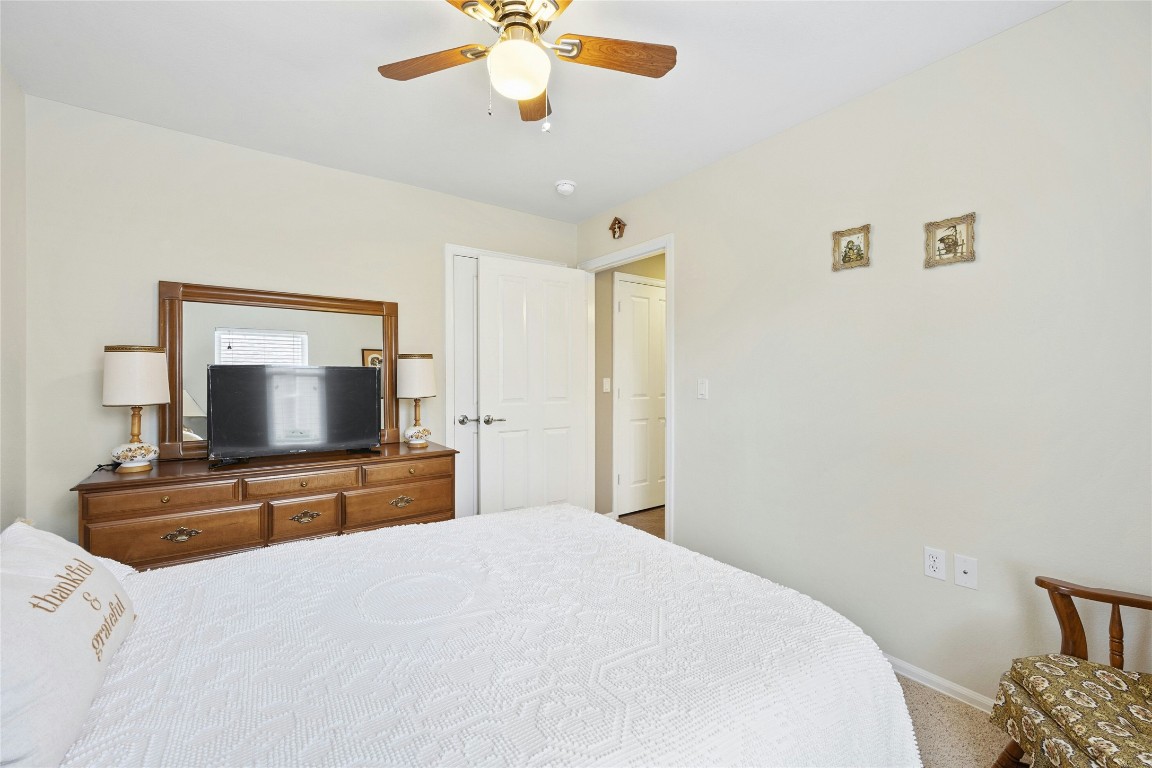 104 Monument Hill Trail Georgetown, TX 78633 - Photo 23 of 30 a bedroom with a bed and a flat screen tv