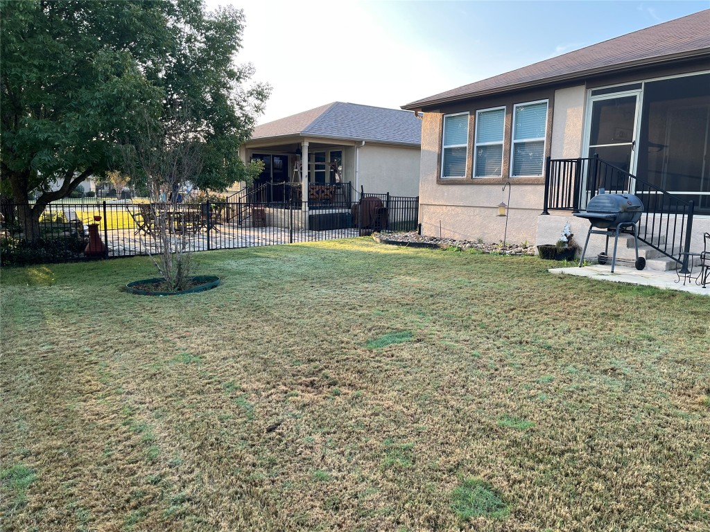104 Monument Hill Trail Georgetown, TX 78633 - Photo 27 of 30 a backyard of a house with yard table and chairs