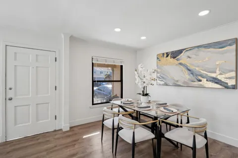 a view of a dining room with furniture and wooden floor