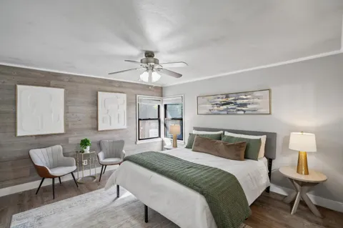 a bedroom with a bed and a chandelier