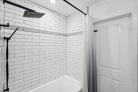 a bathroom with a shower and a bathtub