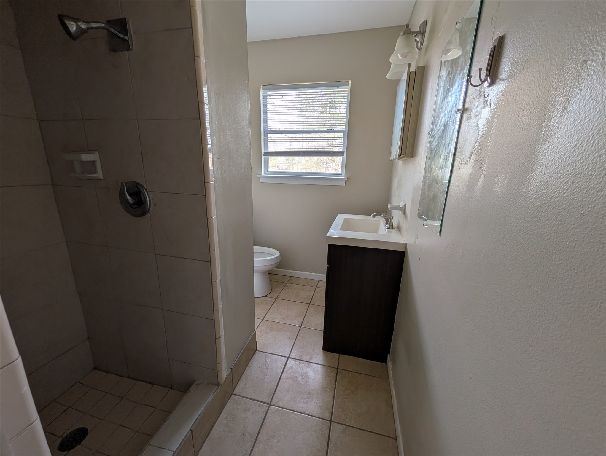 515 Broad Ripple Drive Houston, TX 77336 - Photo 11 of 21 a bathroom with a sink a toilet a window and vanity