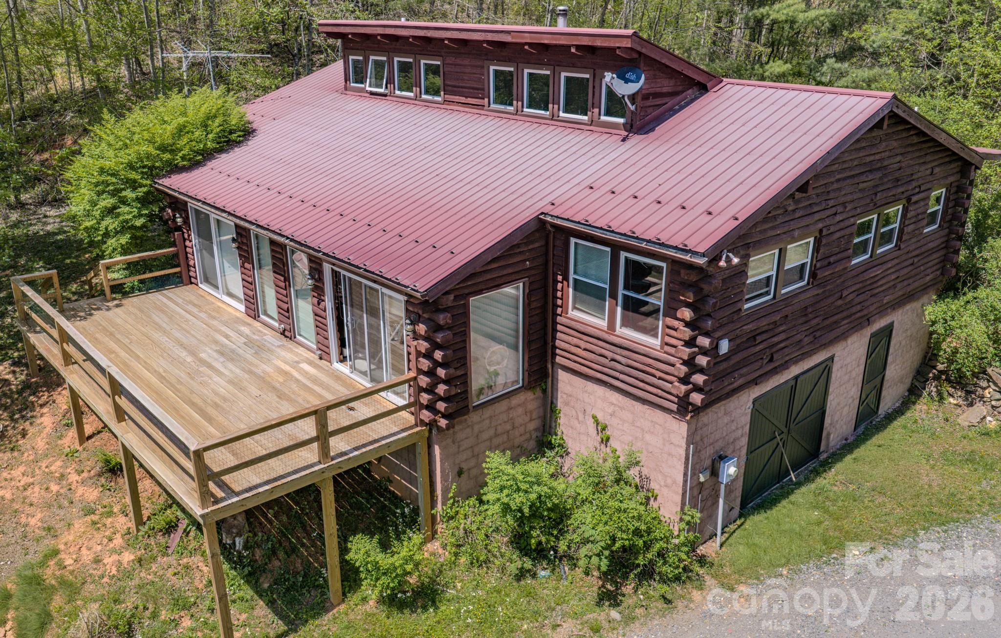 143 Gouge Cemetery Road Bakersville, NC 28705 - Photo 14 of 47 a aerial view of a house with a deck and a yard