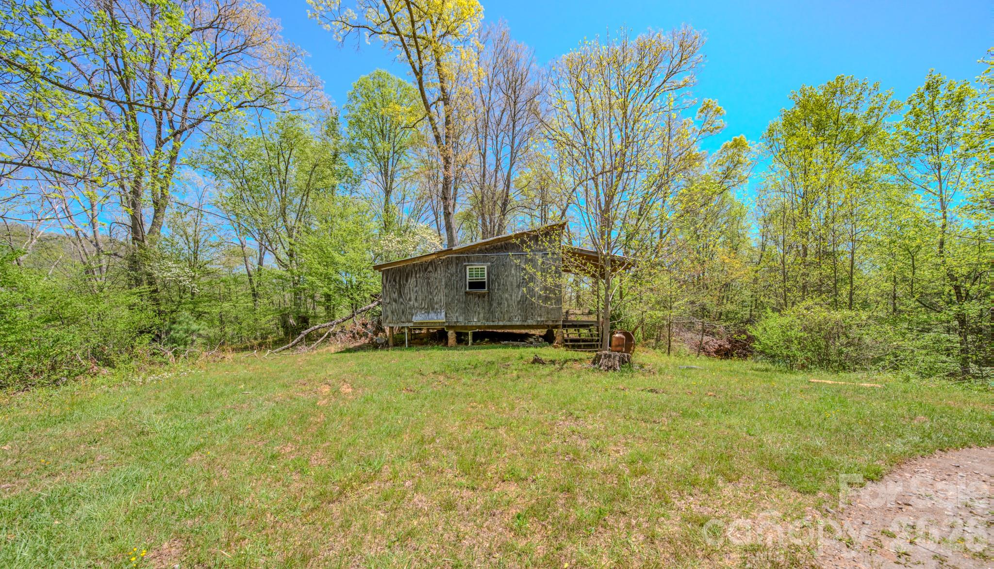 143 Gouge Cemetery Road Bakersville, NC 28705 - Photo 15 of 47 a view of a house with a yard