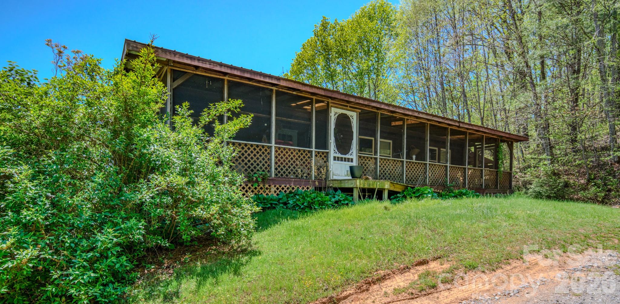 143 Gouge Cemetery Road Bakersville, NC 28705 - Photo 42 of 47 a view of house with backyard and garden