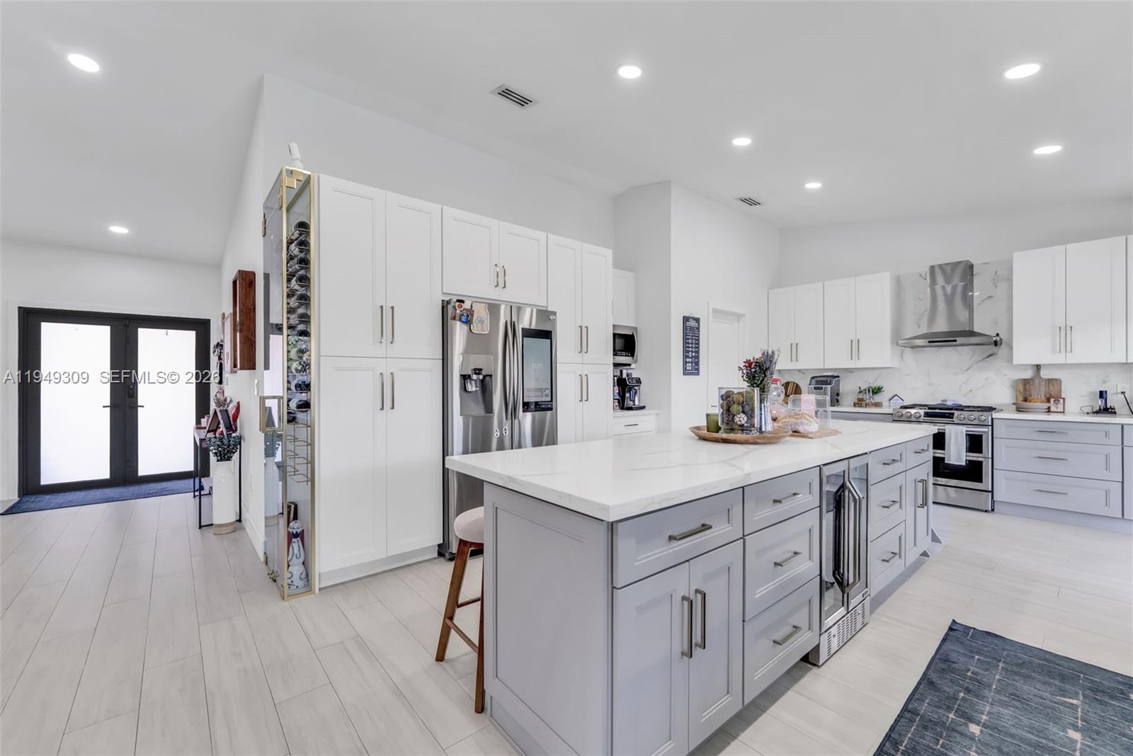 15101 Southwest 144th Court Miami, FL 33196 - Photo 11 of 32 a kitchen with white cabinets sink and stainless steel appliances