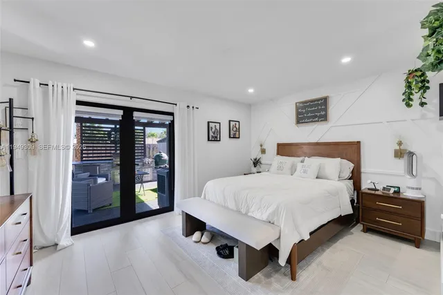 a spacious bedroom with a bed and cabinets