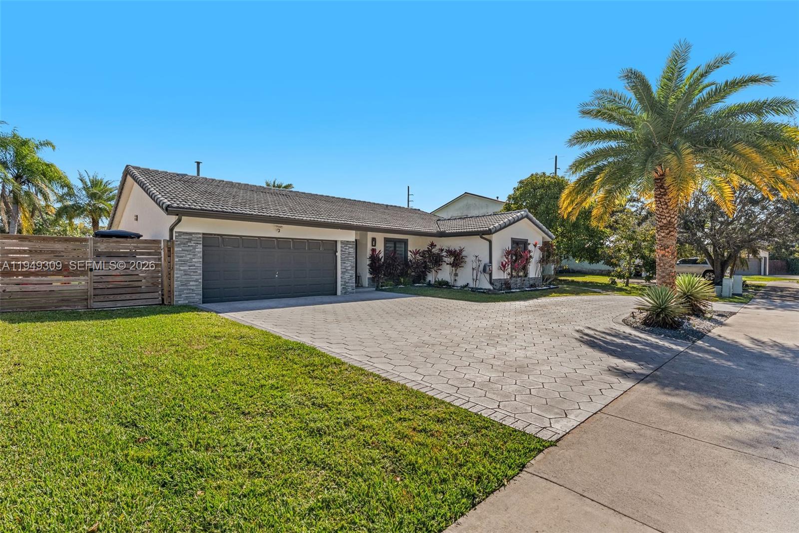 15101 Southwest 144th Court Miami, FL 33196 - Photo 4 of 32 a front view of a house with a yard and garage