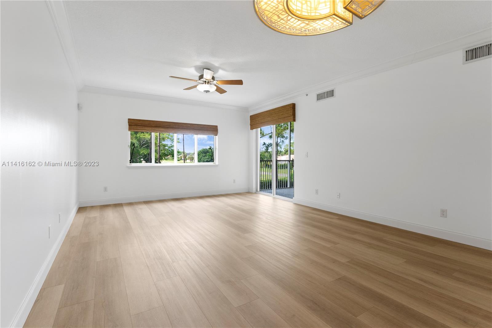 22701 Camino Del Mar, Unit 25 Boca Raton, FL 33433 - Photo 11 of 19 wooden floor in an empty room with a window