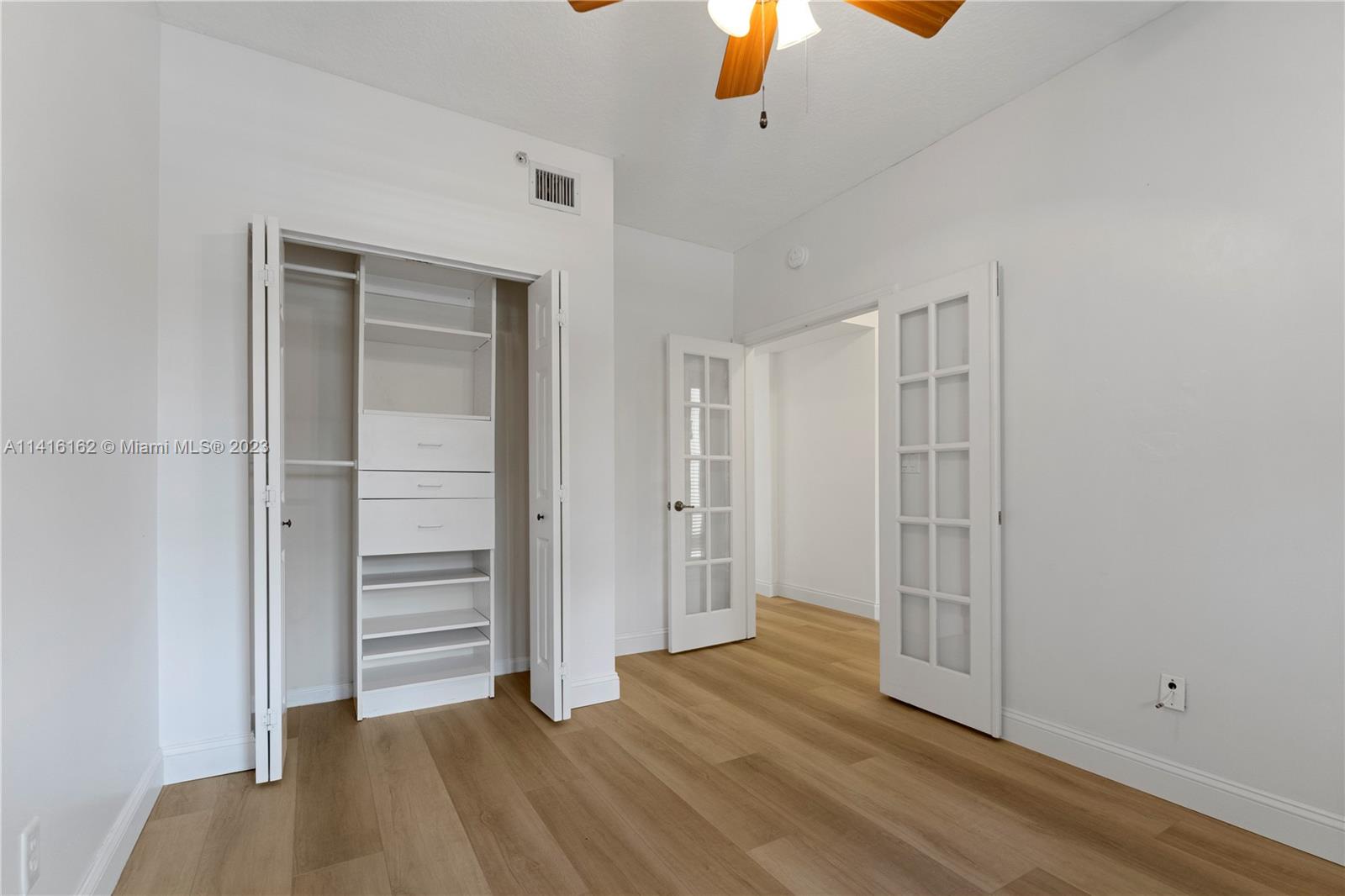 22701 Camino Del Mar, Unit 25 Boca Raton, FL 33433 - Photo 13 of 19 an empty room with wooden floor closet and windows