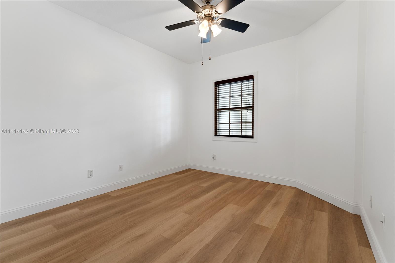 22701 Camino Del Mar, Unit 25 Boca Raton, FL 33433 - Photo 15 of 19 an empty room with a window and ceiling fan