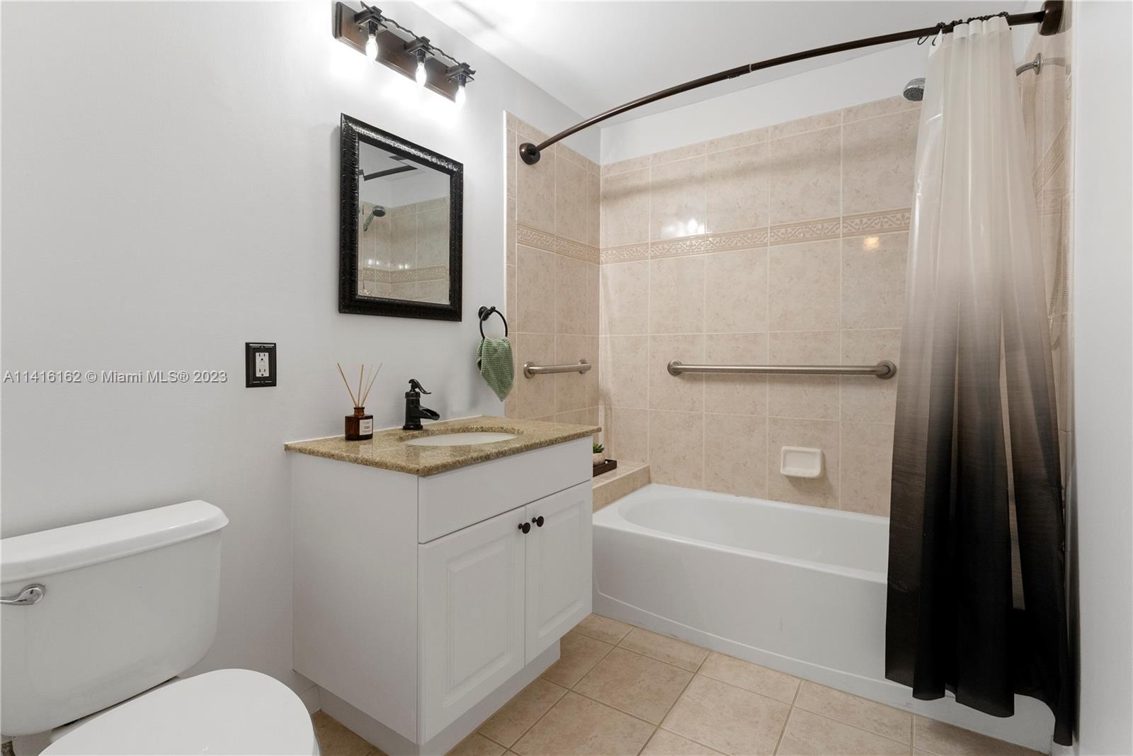 22701 Camino Del Mar, Unit 25 Boca Raton, FL 33433 - Photo 16 of 19 a bathroom with a granite countertop sink toilet and shower