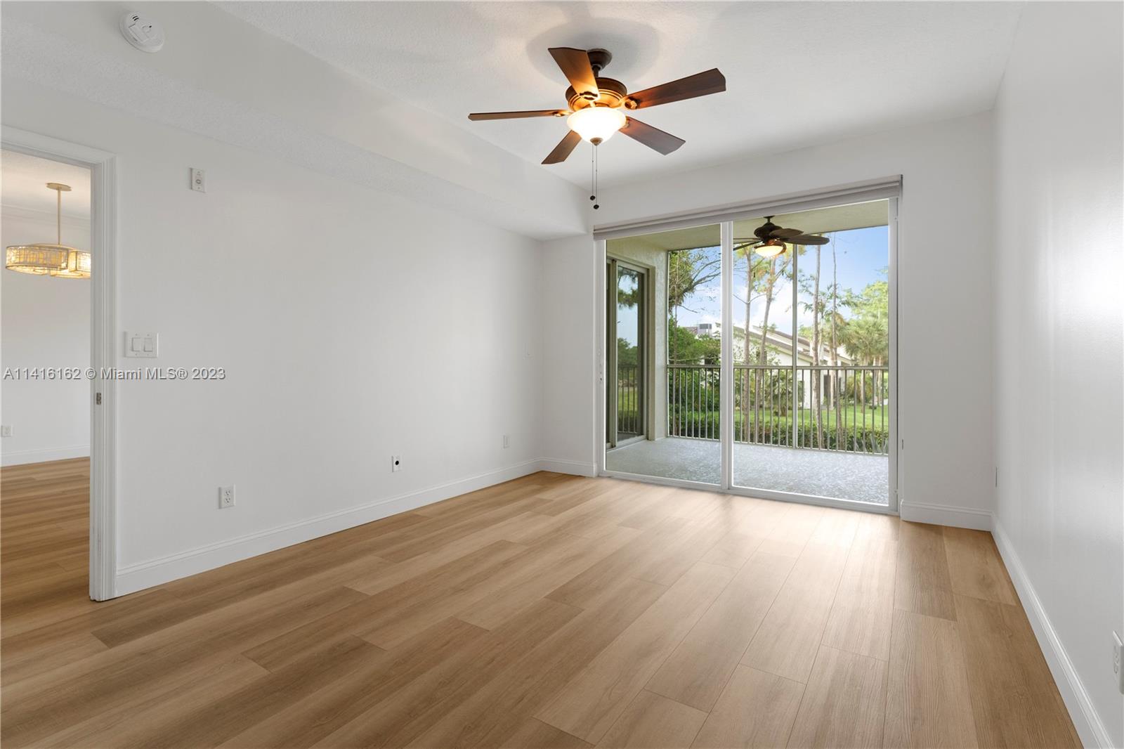 22701 Camino Del Mar, Unit 25 Boca Raton, FL 33433 - Photo 17 of 19 a view of empty room with wooden floor and fan