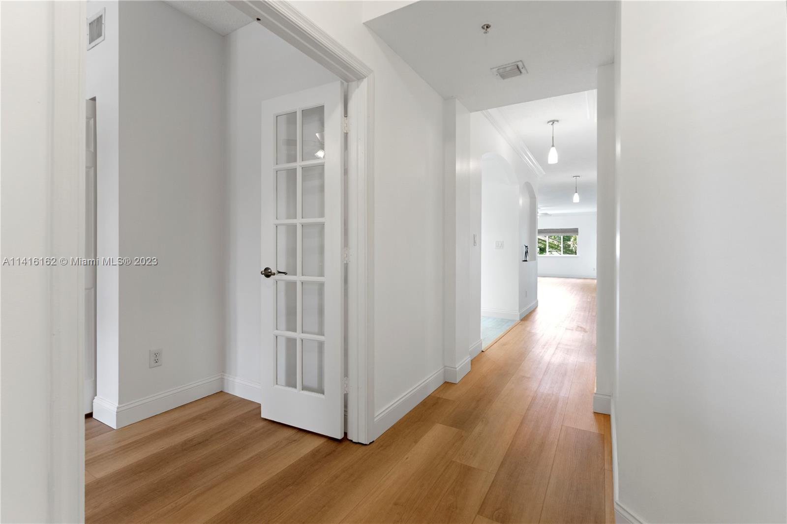 22701 Camino Del Mar, Unit 25 Boca Raton, FL 33433 - Photo 3 of 19 a view of a hallway with wooden floor