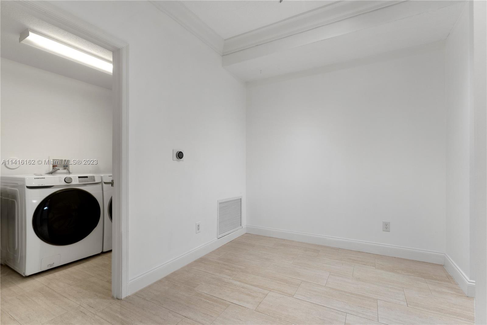 22701 Camino Del Mar, Unit 25 Boca Raton, FL 33433 - Photo 6 of 19 a utility room with dryer and washer