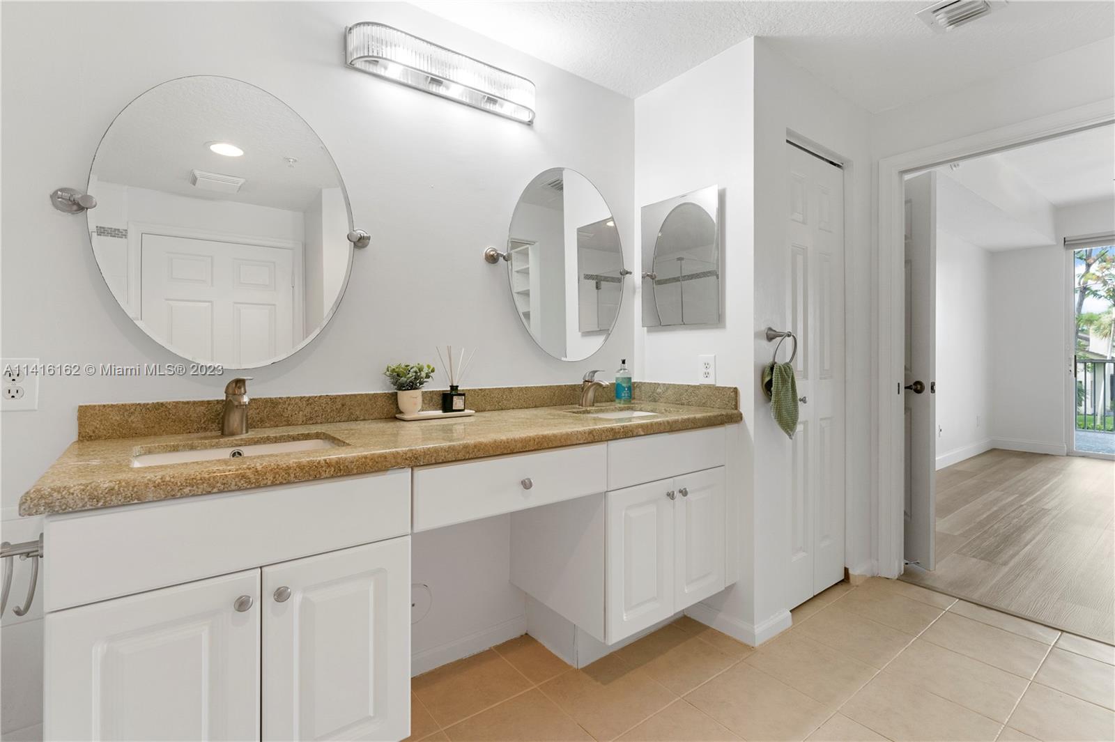 22701 Camino Del Mar, Unit 25 Boca Raton, FL 33433 - Photo 7 of 19 a bathroom with 2 sink and a mirror