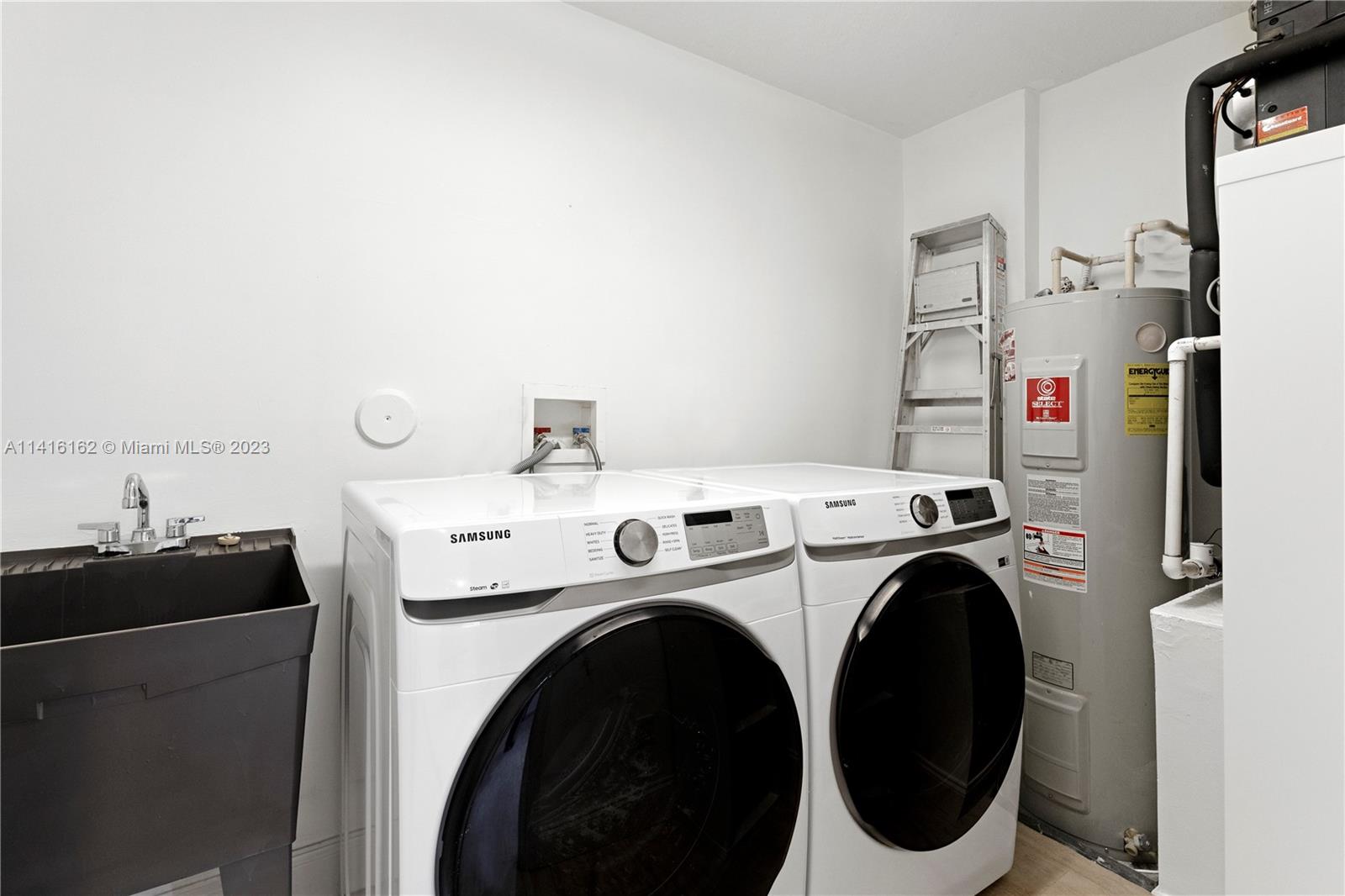 22701 Camino Del Mar, Unit 25 Boca Raton, FL 33433 - Photo 9 of 19 a utility room with dryer and washer