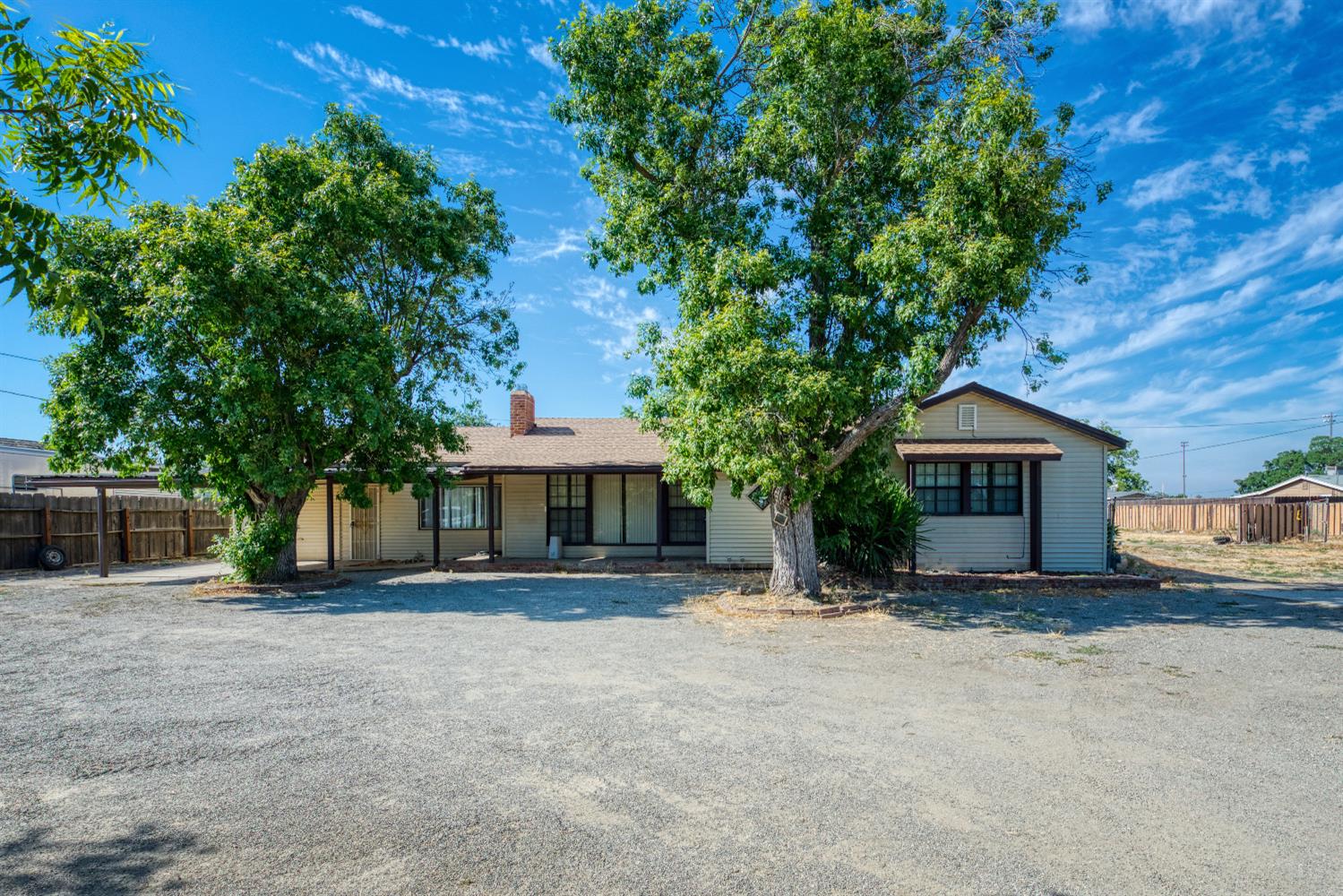 a view of house with outdoor space and trees