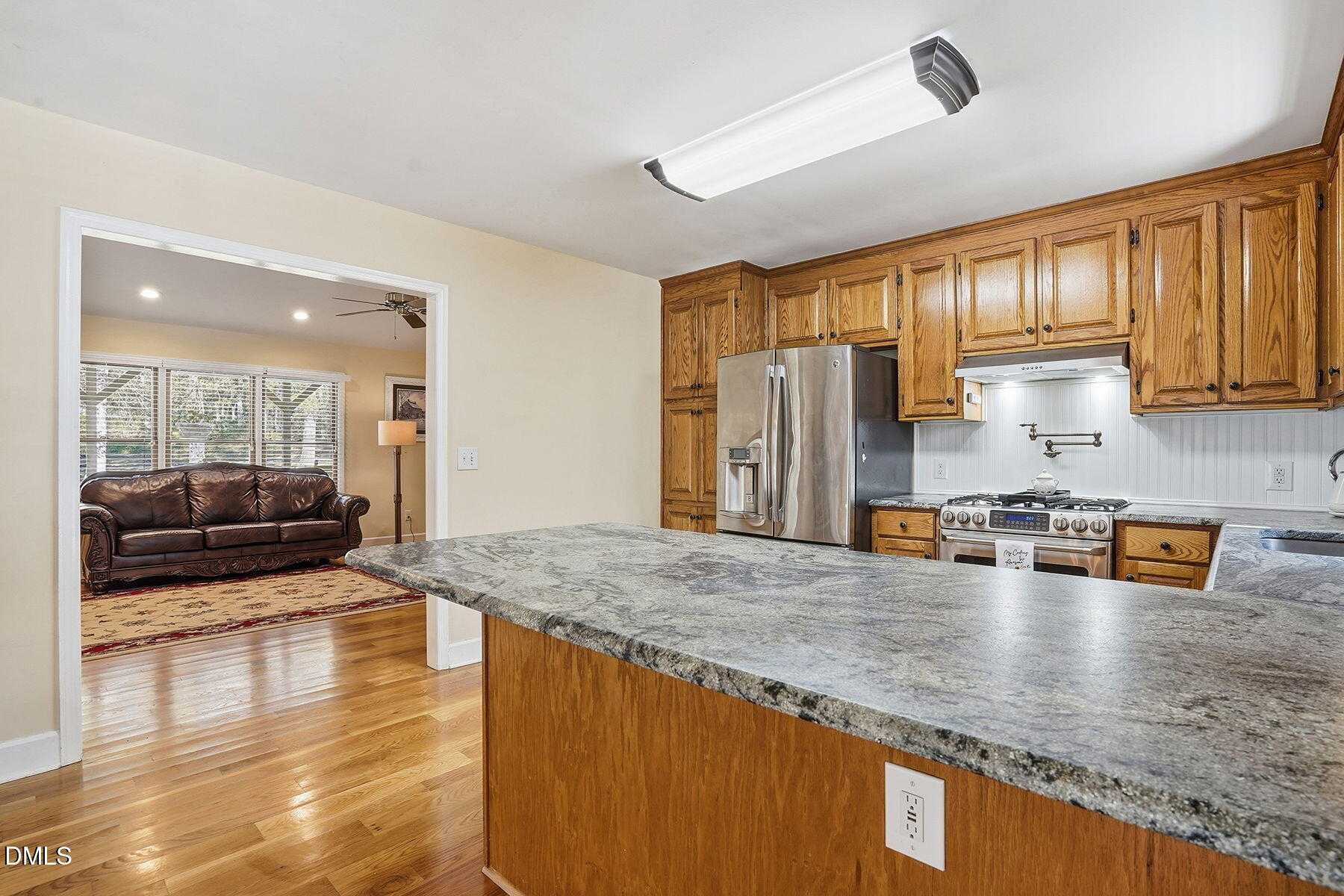 229 Plantation Road Clayton, NC 27520 - Photo 12 of 32 a kitchen with stainless steel appliances granite countertop a sink refrigerator and cabinets