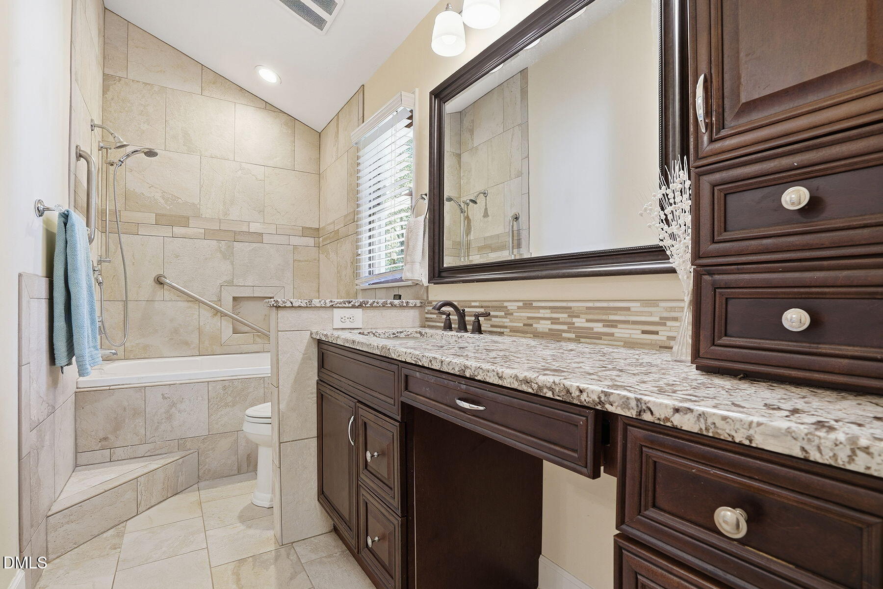 229 Plantation Road Clayton, NC 27520 - Photo 17 of 32 a bathroom with a granite countertop sink a mirror and shower