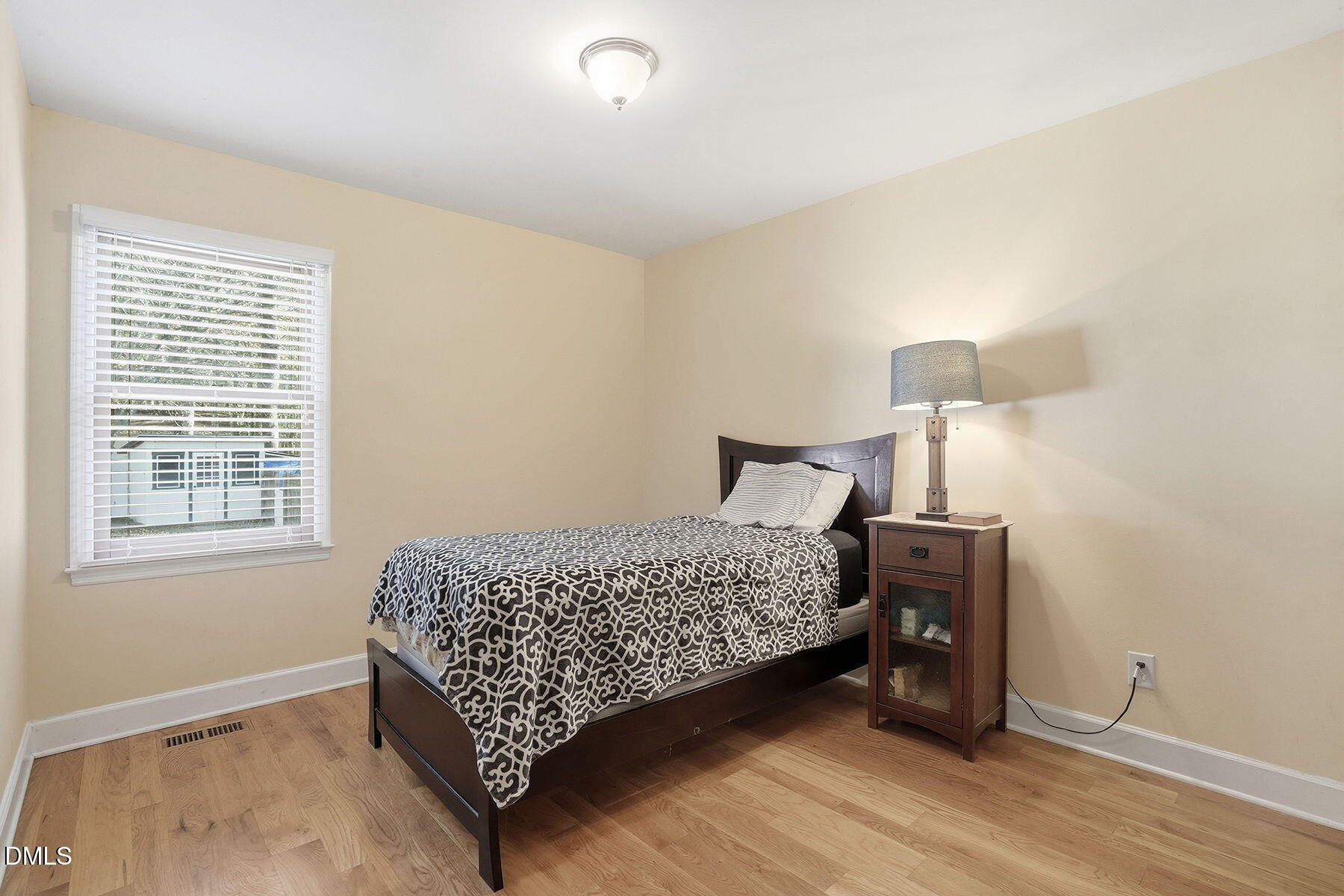 229 Plantation Road Clayton, NC 27520 - Photo 19 of 32 a bed room with a bed and a night stand