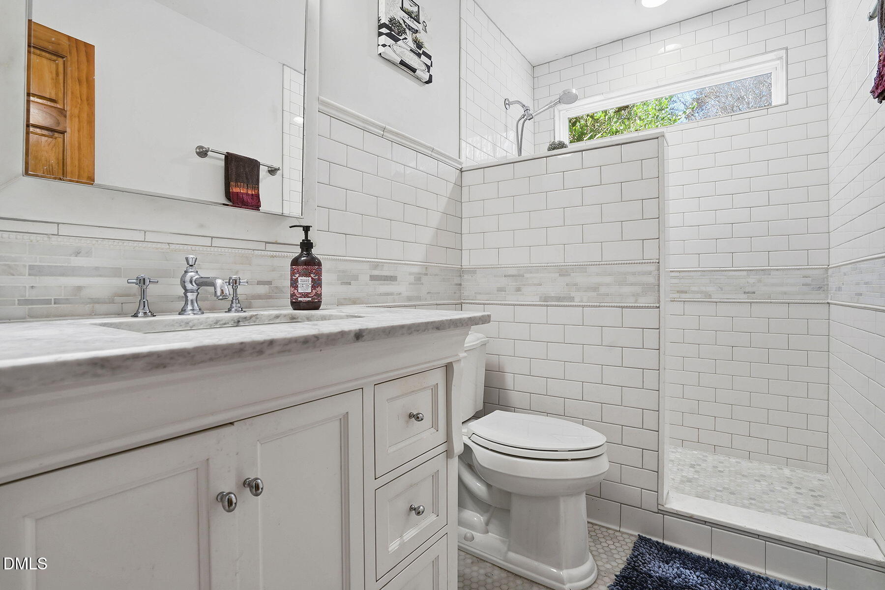 229 Plantation Road Clayton, NC 27520 - Photo 21 of 32 a bathroom with a toilet a sink and mirror