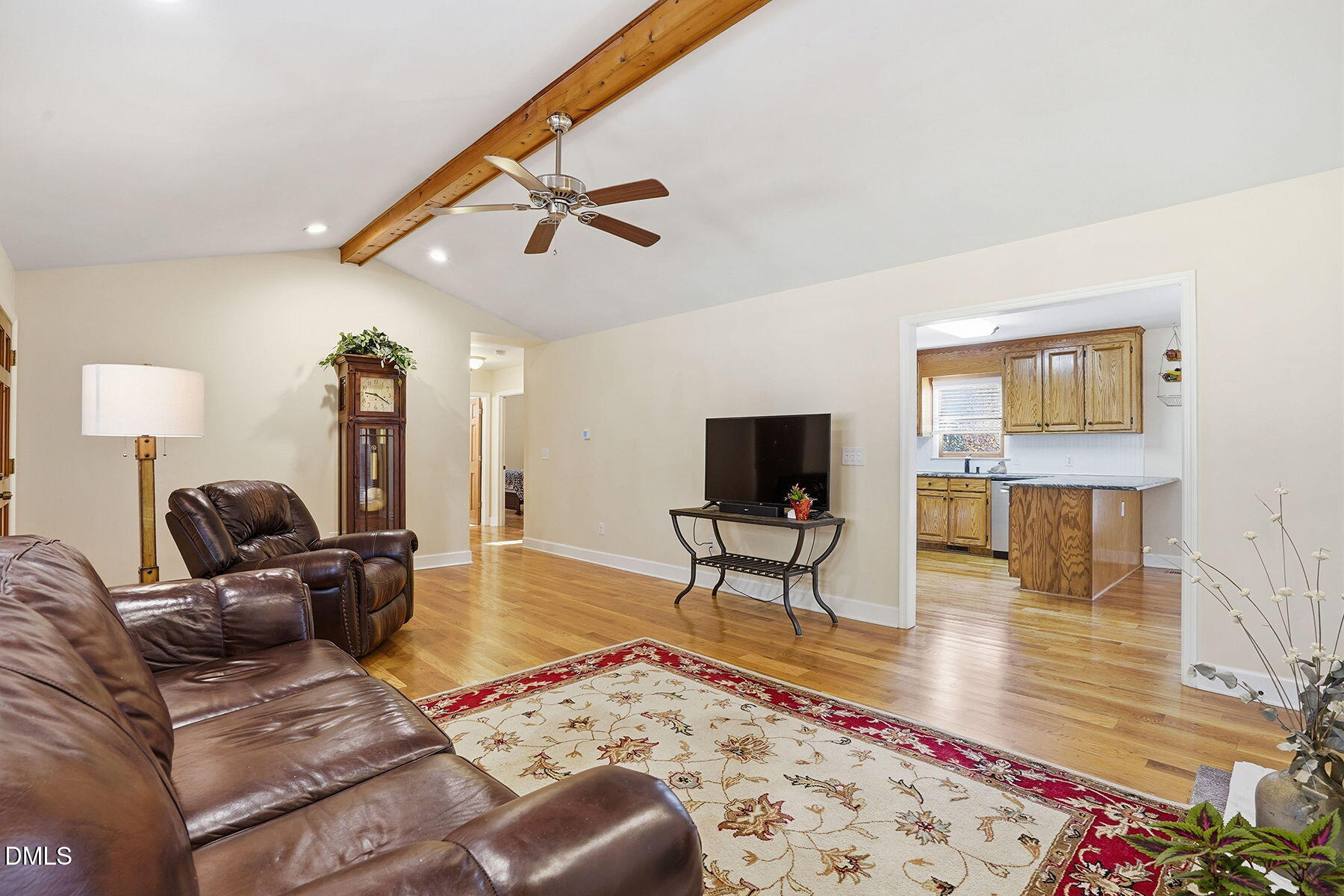 229 Plantation Road Clayton, NC 27520 - Photo 8 of 32 a living room with furniture and a flat screen tv