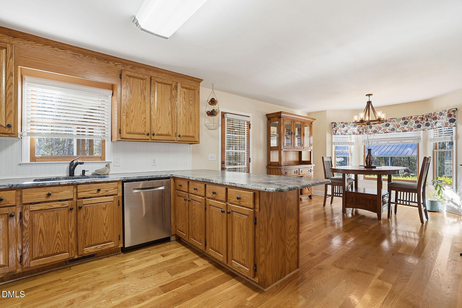 229 Plantation Road Clayton, NC 27520 - Photo 9 of 32 a kitchen with stainless steel appliances granite countertop a stove top oven a sink dishwasher and cabinets with wooden floor
